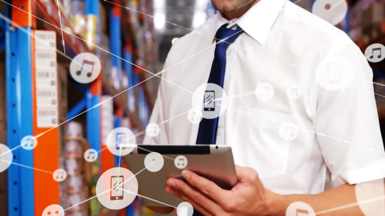 In warehouse, businessman using tablet with animation of digital network icons