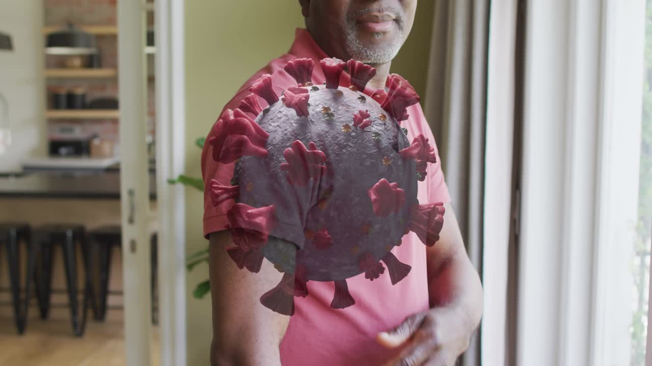 Senior man moving hand toward shoulder after 3D virus sphere appearing over arm, showing health