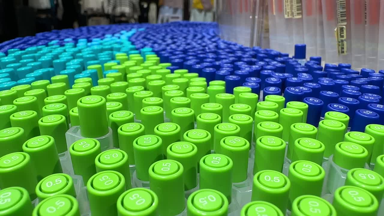 Hundreds multiple Light Green and Blue Pens stationery store. Tops visible grouped vertically in array