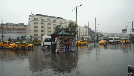 eminonu district in istanbul on rainy day with traffic and passenger waiting for ferry near the pier