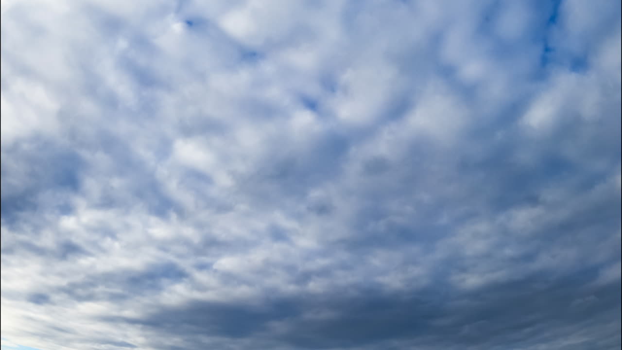 Dramatic cloudscape covering the horizon. Grey heavy clouds evanesce gradually in the sky. Low angle view.