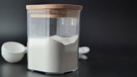 harina en un recipiente transparente con vasos medidores