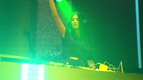 DJ-on-stage-in-disco-night-club-mixing-techno-music-beat