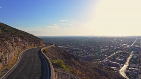 car driving on scenic drive in el paso, texas. looking at the cesar e. chavez border highway (375) and border wall in el paso, tx before title 42 ends. 4k drone footage.