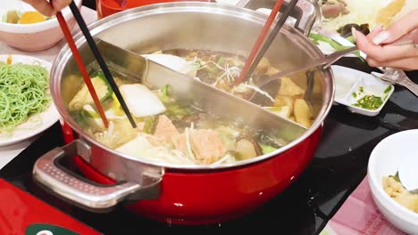 preparing and enjoying hotpot soup together