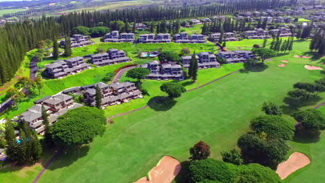aerial flyover luxury resort with similar buildings on hawaii during summer