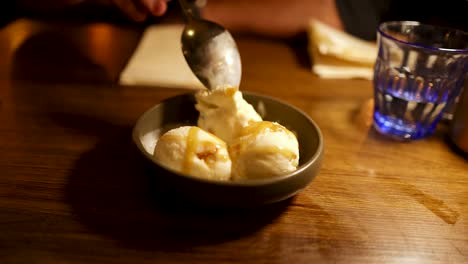 scooping ice cream from a bowl