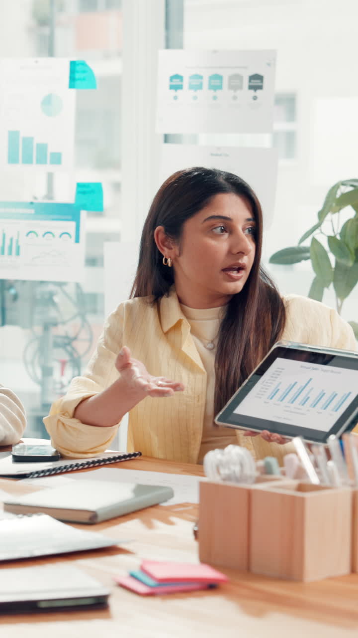 Young Woman Presenting Data on Tablet in Office Meeting