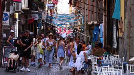 people walking and interacting on a narrow street