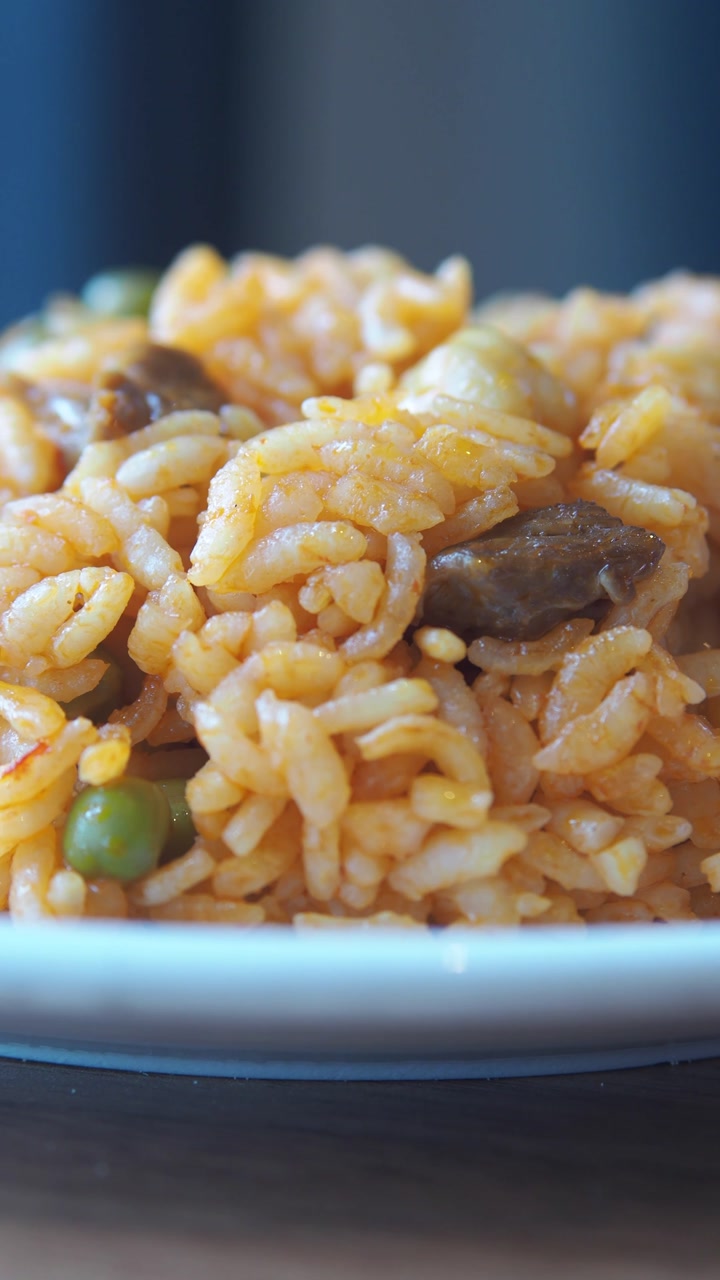 Appetizing Close-up of a Savory Rice Dish with Meat and Peas
