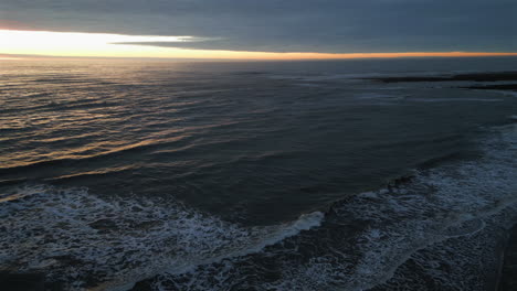 Establishing-Aerial-Drone-Shot-Over-Sea-at-Stunning-Sunrise-in-North-Yorkshire-UK