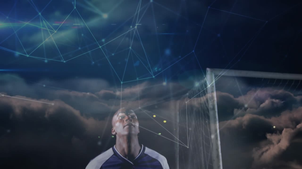 Male soccer player bracing, jumping as opponent entering, contesting goal under night network lines