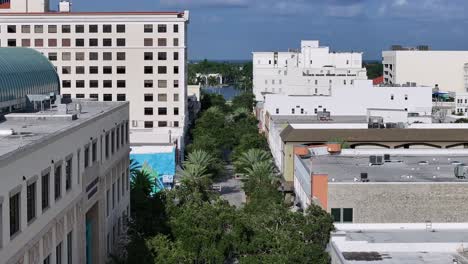 Beautiful-street-with-palm-trees-between-high-rise-buildings-in-West-Palm-Beach-Downtown