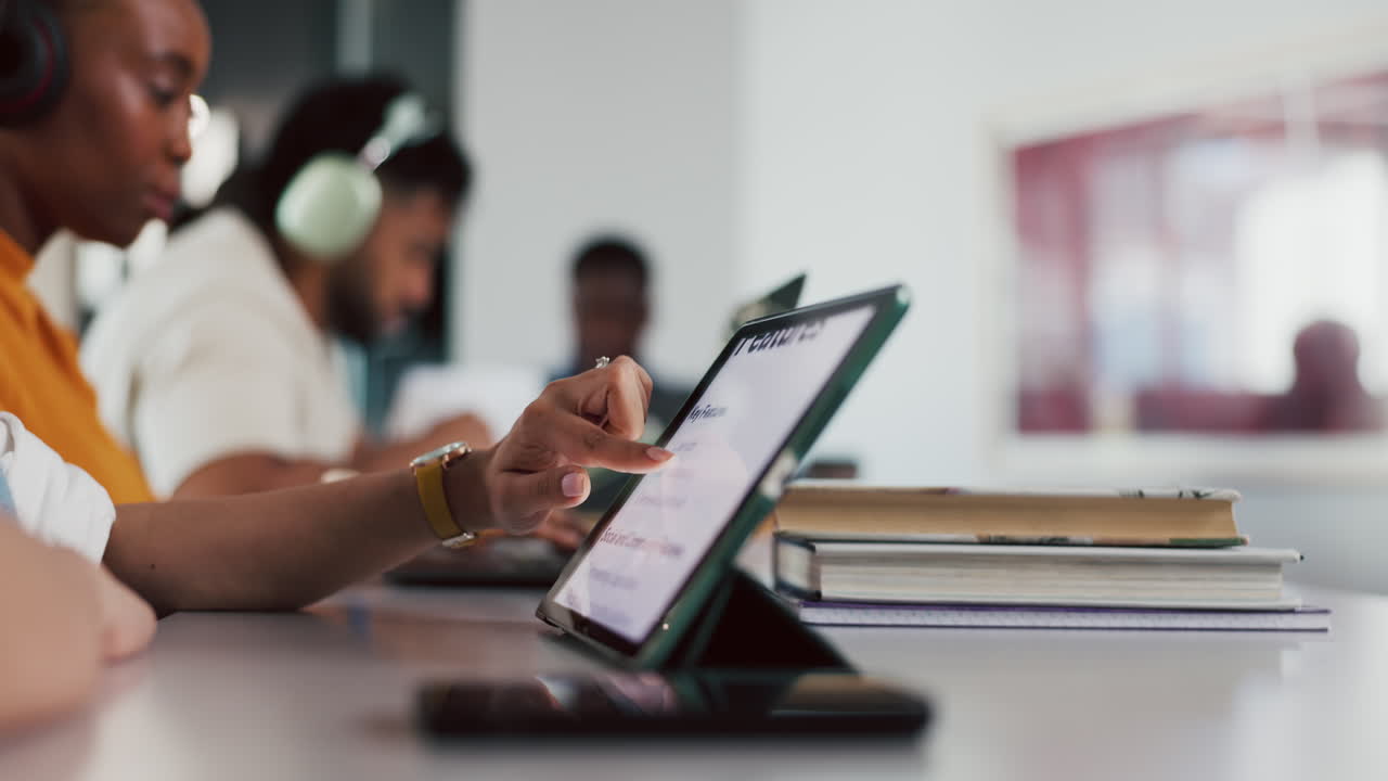 Person's Hand Tapping and Scrolling on a Digital Tablet in an Office