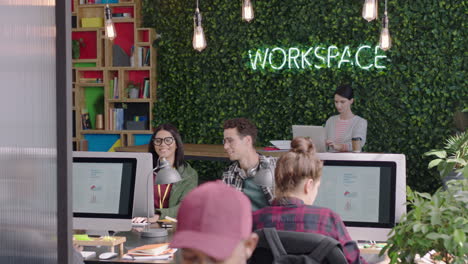 young business people working team leader man training intern pointing at computer screen sharing ideas showing support colleagues collaborating in diverse modern office