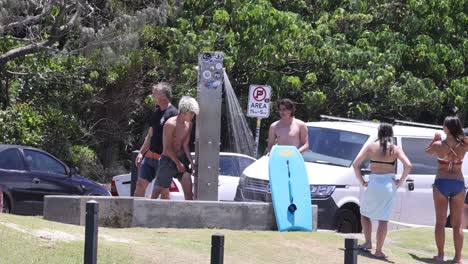 group of surfers getting ready near their cars