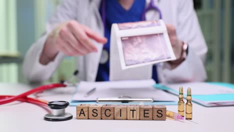 a doctor examines a medical scan with the word 'ascites' displayed