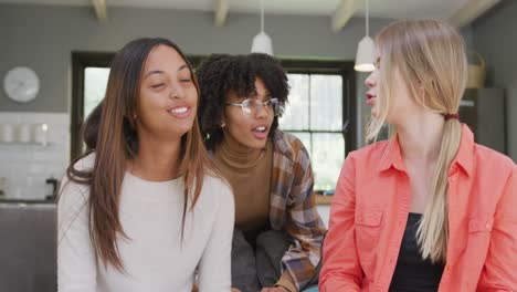portrait of happy diverse teenager girls friends having video call at home, slow motion