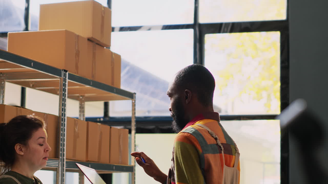 Warehouse workers organizing boxes on shelves