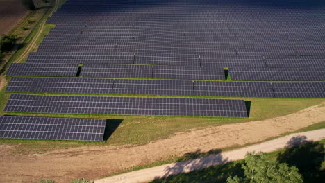 Aerial-top-down-shot-of-lighting-solar-farm-panels-and-shadow-covering,4K