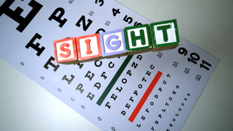 Colorful blocks spelling out sight falling on eye test
