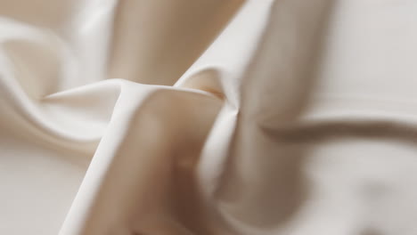 close up of white shiny silk cloth in slow motion