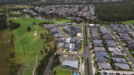 aerial shot of australian roads in lazy australian suburb with traffic and cars