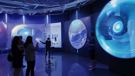 people engaging with interactive displays in a futuristic science museum exhibit. learning about ocean exploration through technology