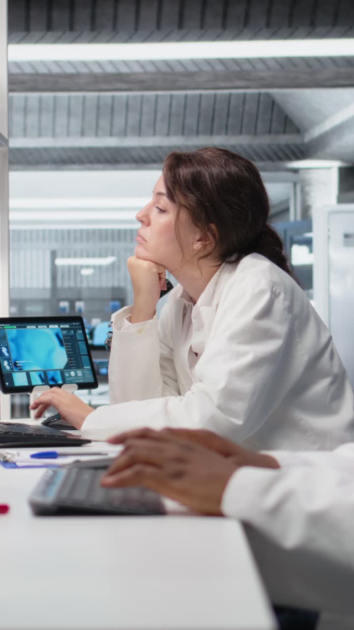 Vertical video Diagnostic laboratory manager overseeing scientists looking at molecular models