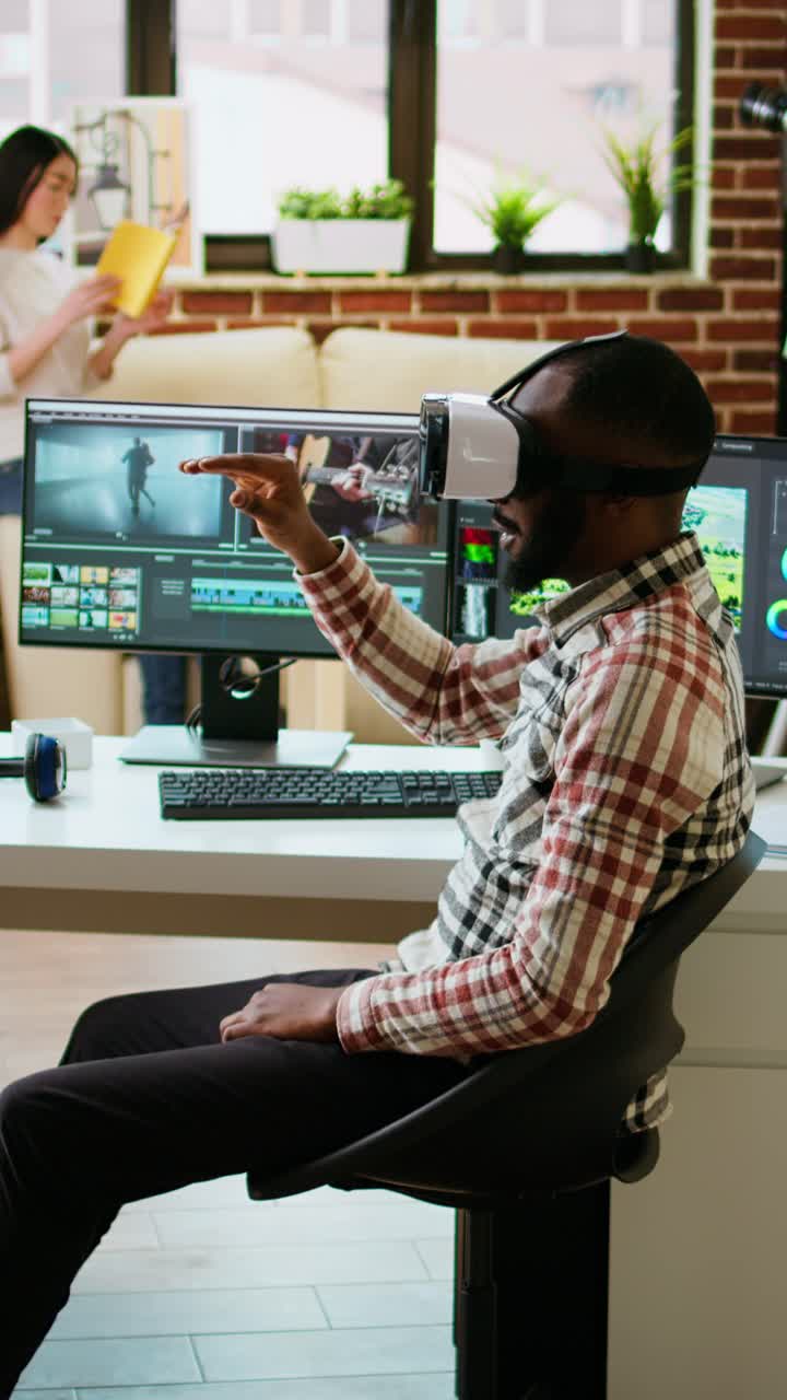 Vertical Video African american editor uses virtual reality glasses to do color grading