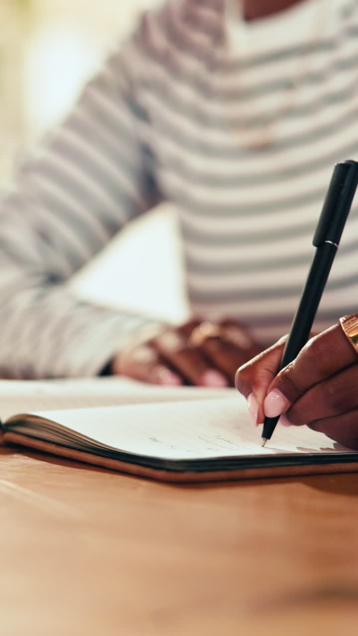 Young Woman Writing Notes in a Notebook with a Pen