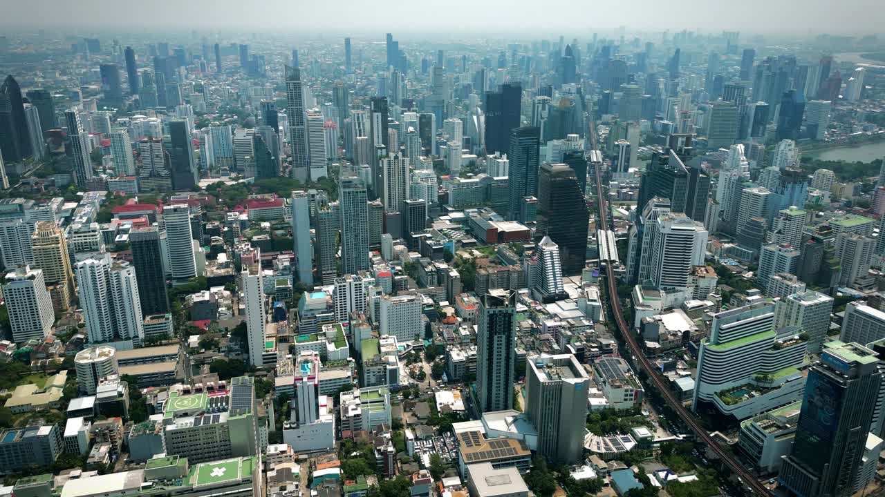 Aerial Scenic Drone Footage of the Skyline of Downtown Bangkok, Thailand Covered in Smog on a Sunny Day during the Smokey Burning Season