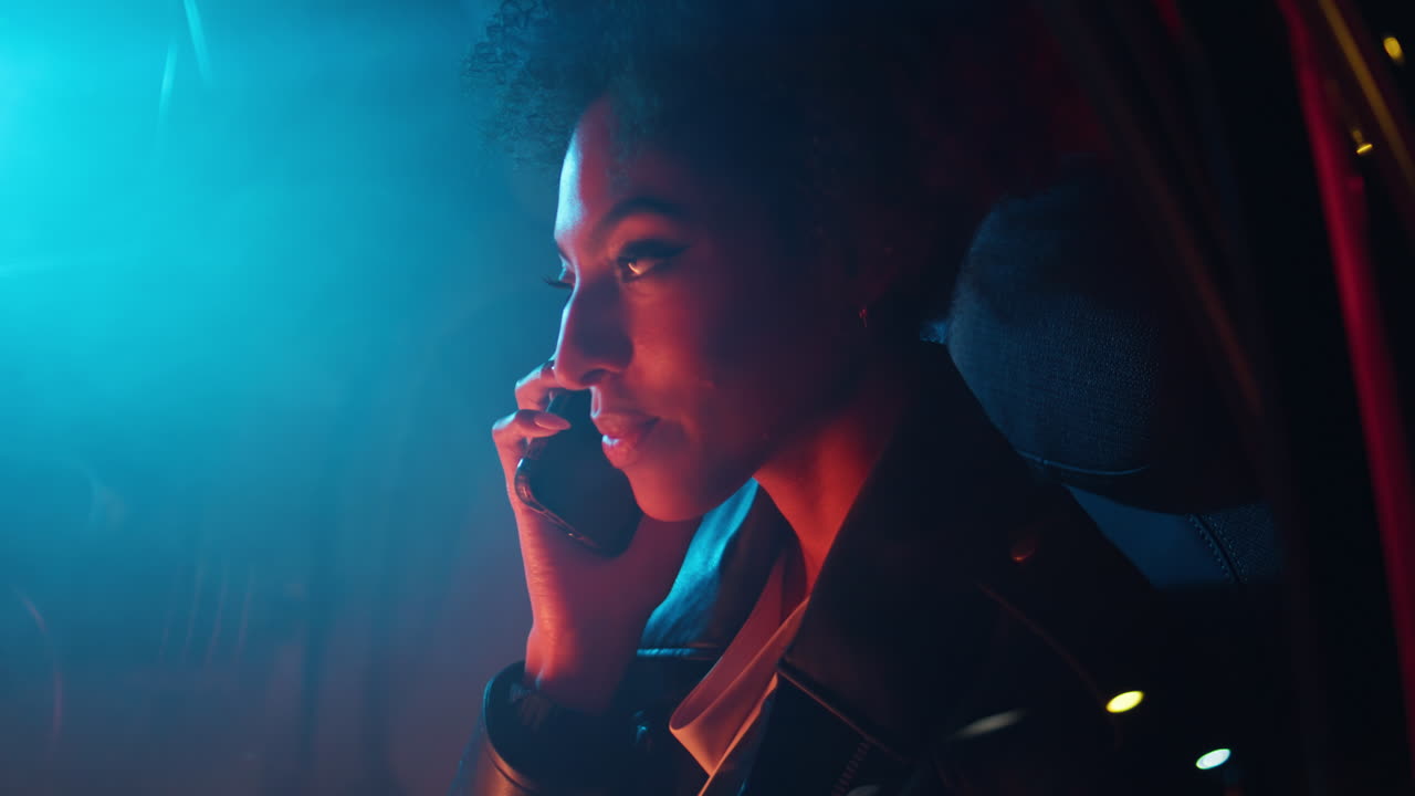 Girl answering phone call sitting car backseat at night closeup. woman