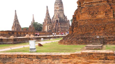 tourists wander ancient temple grounds in ayutthaya