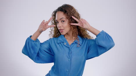 Woman,-face-and-peace-hand-in-studio-on-a-white