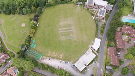 Drone-view-of-the-Devon-and-Exeter-Squash-Club,-showcasing-its-modern-facilities-and-green-surroundings-in-Exeter,-UK