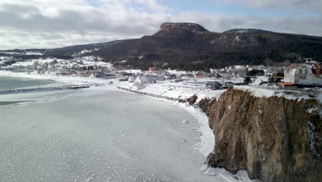 drone shot of percé village during winter