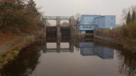 Drone-shot-of-small-hydro-power-plant-Smirice-on-Czech-Labe-river-on-foggy-day