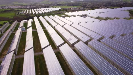 photovoltaic solar power station greenhouse, vast renewable energy field, aerial