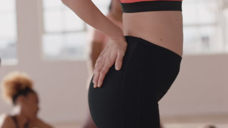 yoga-class-young-caucasian-woman-stretching-ready-for-early-morning-workout-in-fitness-studio-at-sunrise