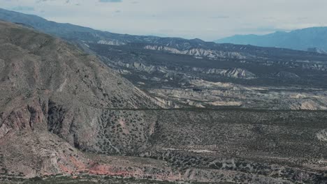 aerial drone view of rugged dry desert mountain terrain in amaicha del valle