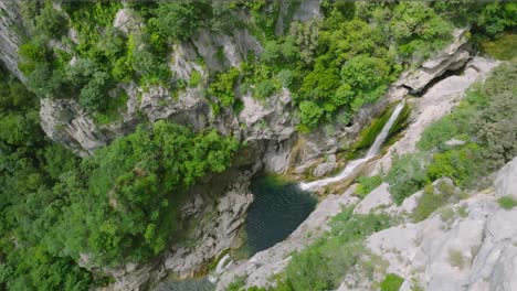 cetina river in croatia, waterfall passage through dramatic cliff valley, aerial