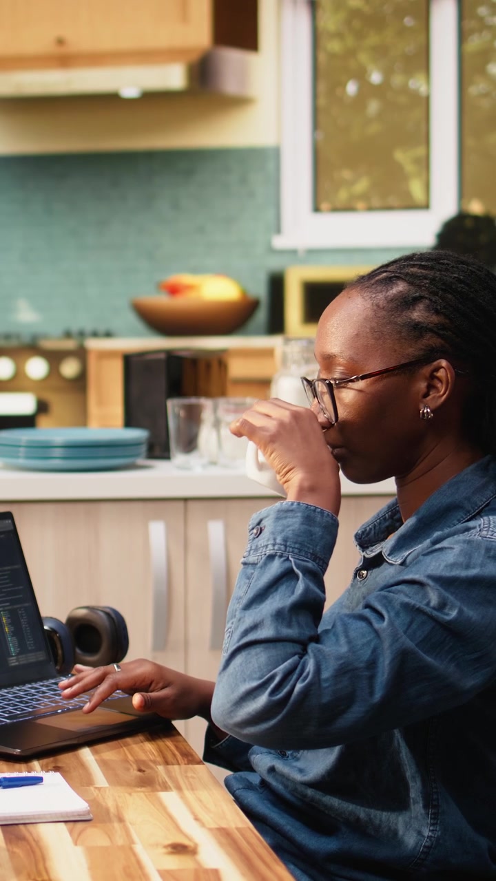 Vertical Video Adult woman using laptop to write programming code and develop software