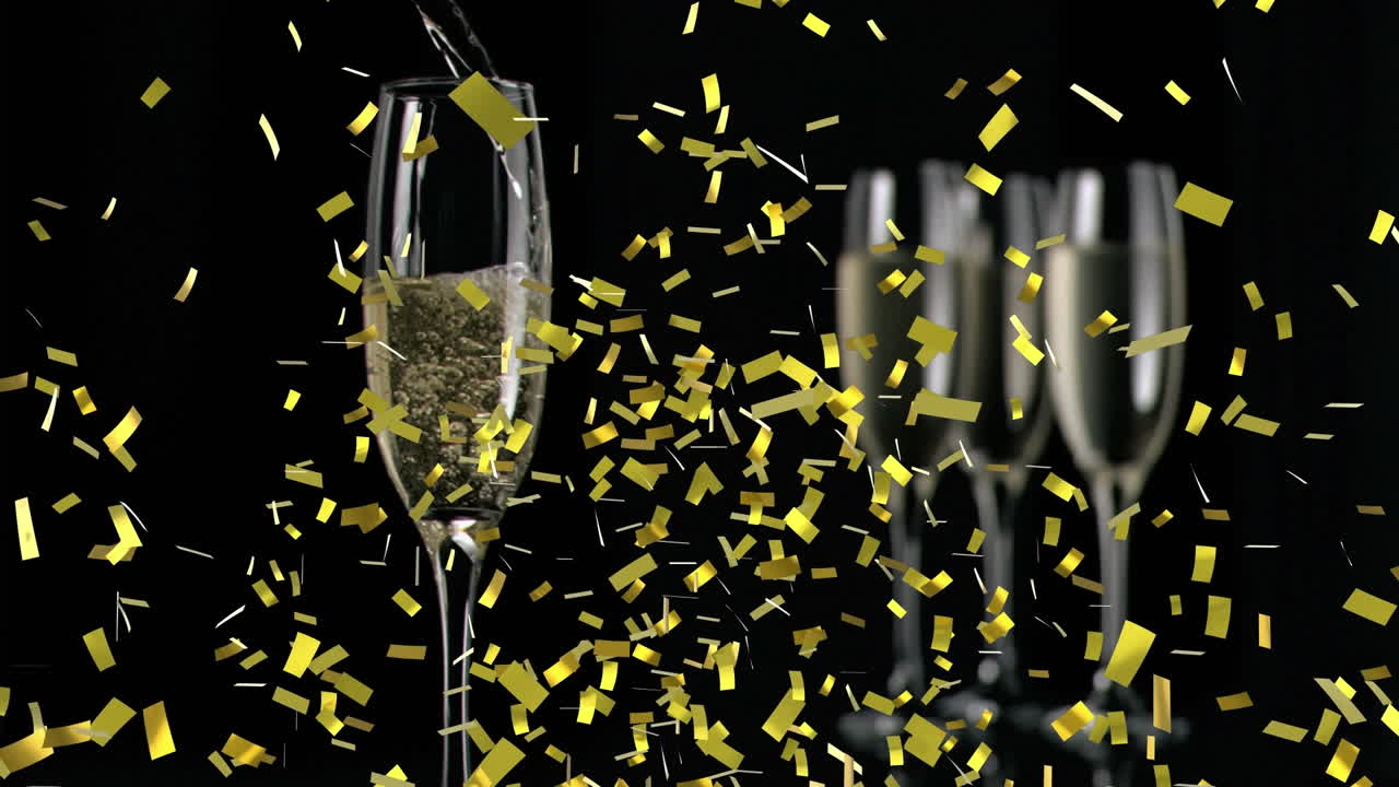 검은색 바탕에  ⁇ 페인 잔 위에 떨어지는 금색 콘페티의 애니메이션