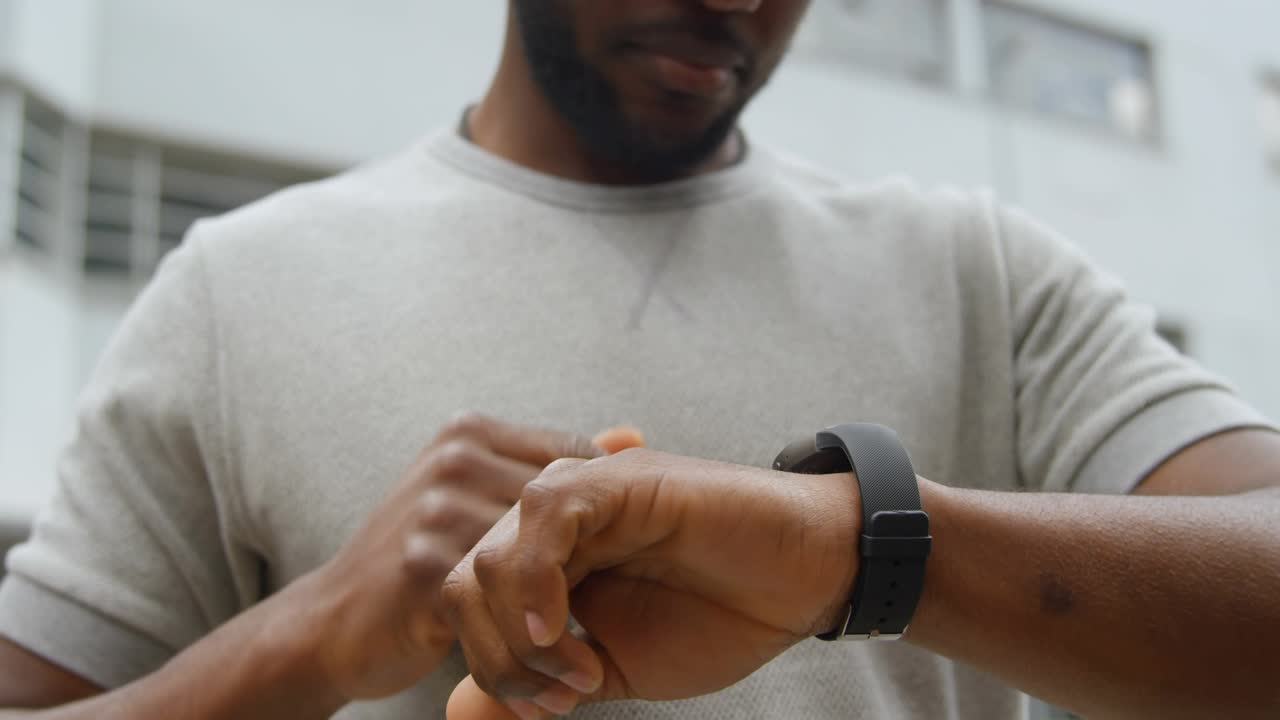 Man tapping wrist device, generating multiple thumbs-up icons while showing social media likes