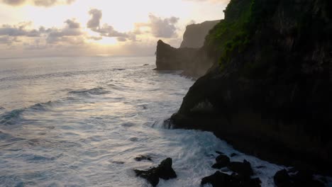 silhouette of majestic cliffs beside coastline of beach