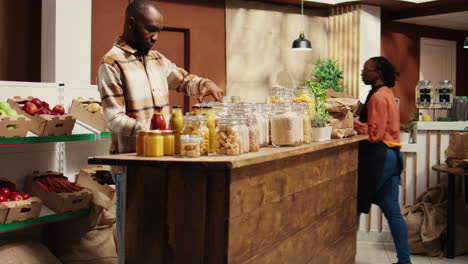 client examining organic bulk products stored in reusable jars