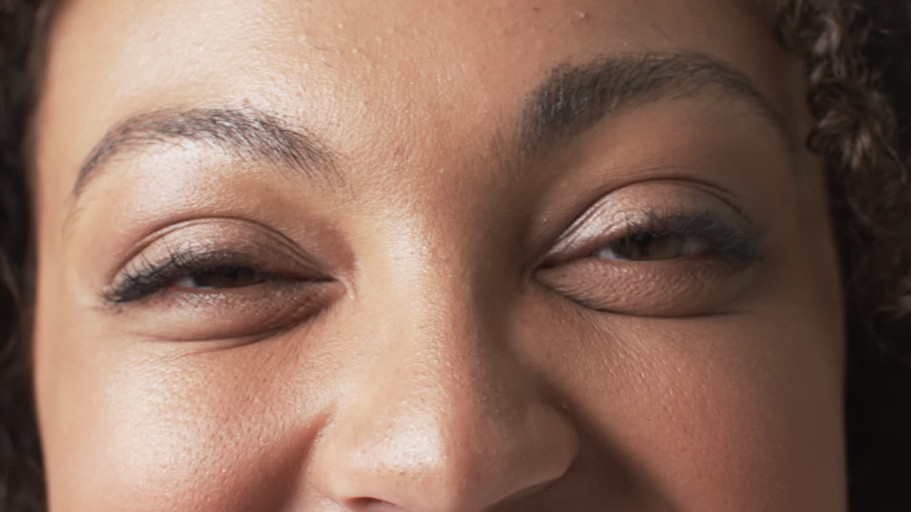 Biracial beautiful plus size woman smiling warmly with eyes closed