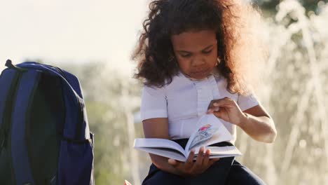 young girl reading outdoors