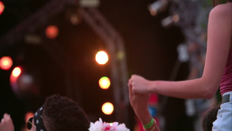 back view of friends in the audience at a music festival